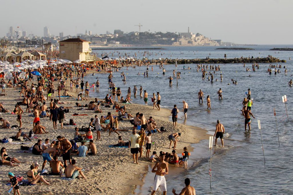 Beachgoers hang out on the shore of the Mediterranean sea in Tel Aviv as coronavirus disease restrictions eased in Israel in May 2020. 