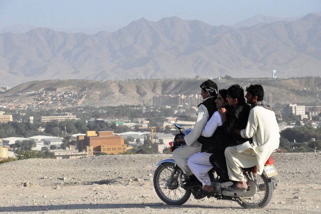 Passengers on a moped in Kabul, Afghanistan. Airline insurers want more security at Kabul's airport and proper air traffic control before they cover commercial flights, Reuters reports.