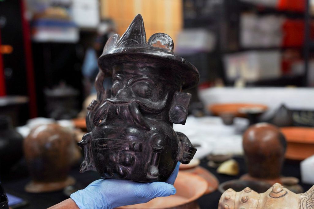Archaeologist Sergio Gomez displays a pot that's shaped in the image of storm god Tlaloc, found inside a 2,000-year-old tunnel built under the ornate Feathered Serpent Pyramid, which Gomez believes recreated the underworld and was used to initiate new rulers among other religious rituals, in the ruins of Teotihuacan, in San Juan Teotihuacan, Mexico August 12, 2021.