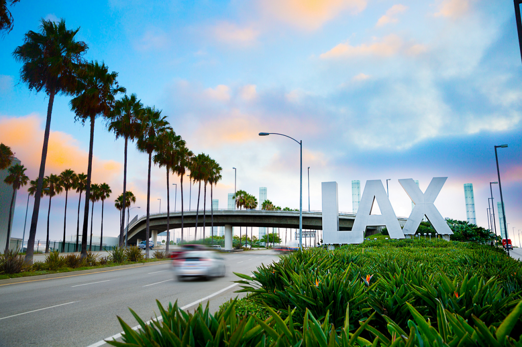 car driving past LAX airport sign