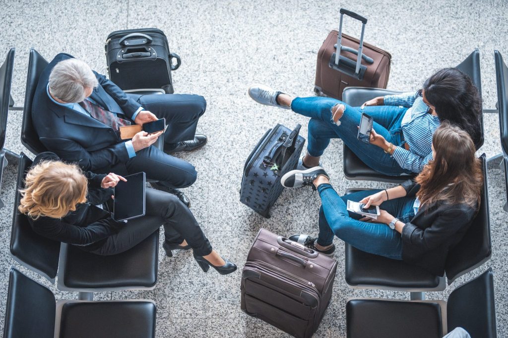 Airline passengers accessing 5G technology on their smartphones.