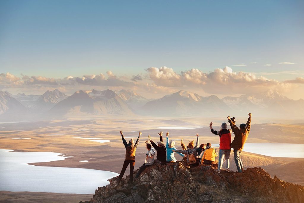 travelers hiking to the top of a mountain