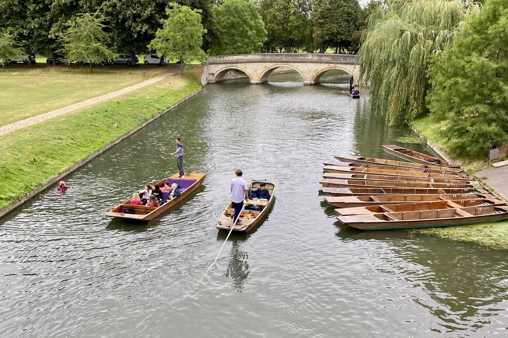 Tourists on punter boats on the Cam River in Cambridge, England. 