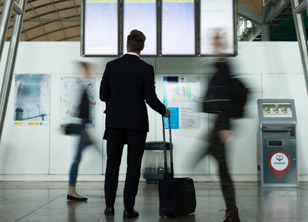 Man Exploring Timetable In Airport