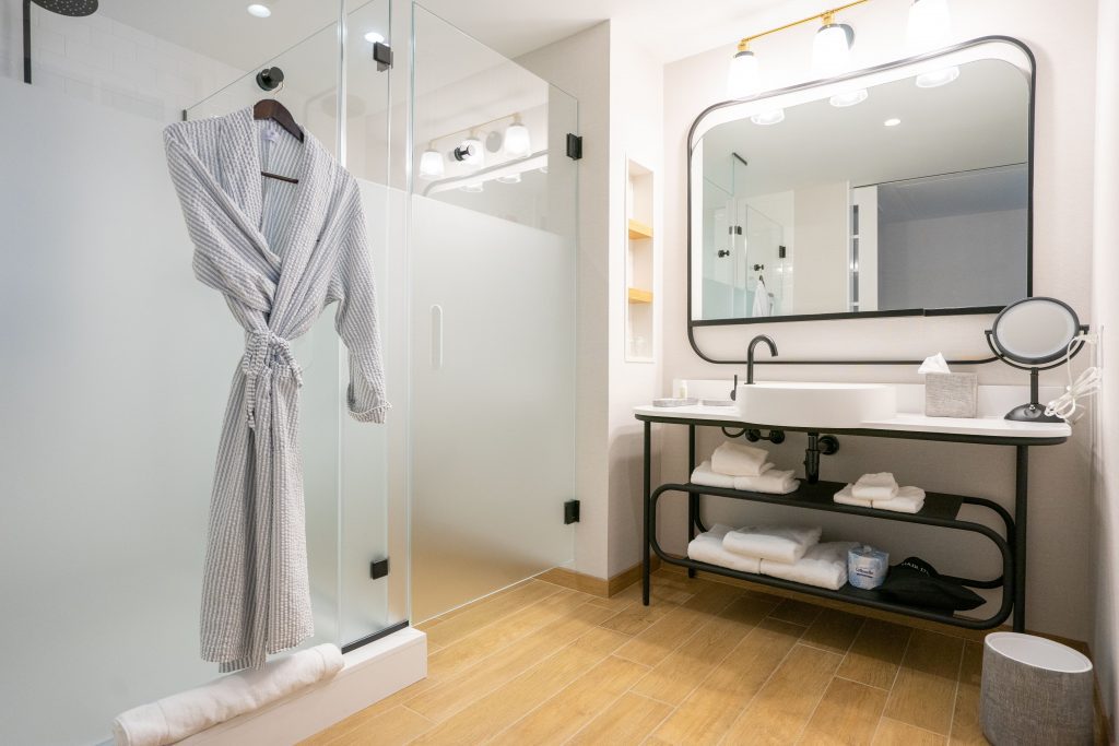 Open-concept and glassed-in bathrooms may look nice on paper, but guests aren't always thrilled by them. Owners say there's a method behind the design tactic and are providing fixes like frosted glass on doors (Pictured: the Brenton Hotel in Rhode Island).