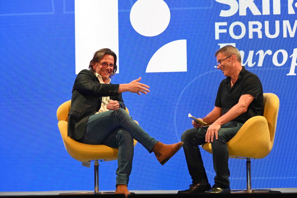 Carlo Olejniczak, Booking.com's vice president and managing director of Europe, Middle East and Africa, on stage with founding editor Dennis Schaal at Skift Forum Europe in London on Thursday