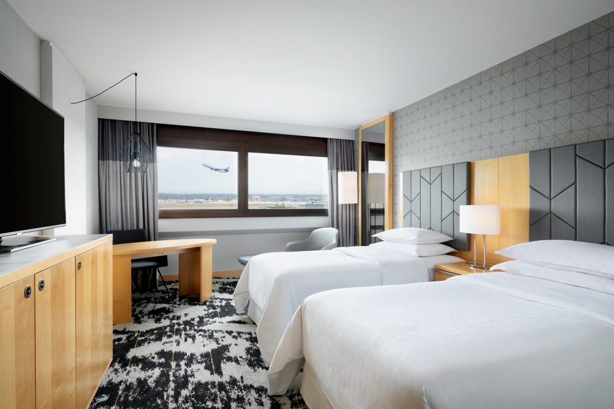 Companies like Marriott are boosting amenities offered at their hotels near major airports (pictured: a guest room at the Sheraton near the Frankfurt airport in Germany). 