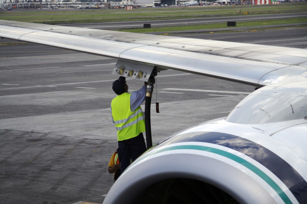 A worker fueling a jet
