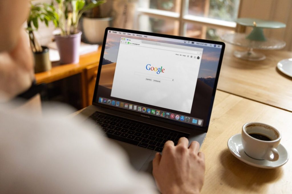 Google on a laptop screen and coffee cup.