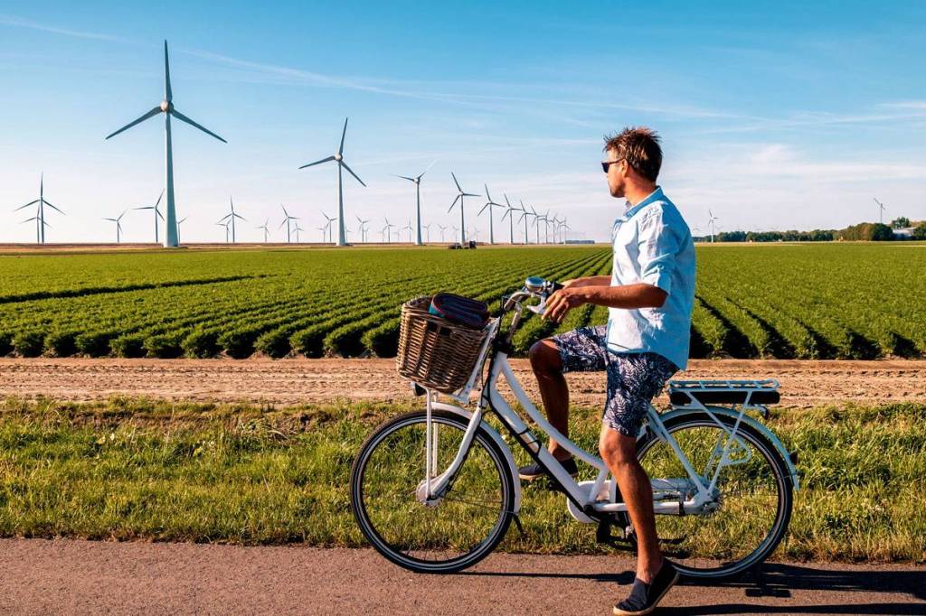 Sustainability wind farm and bicyclist