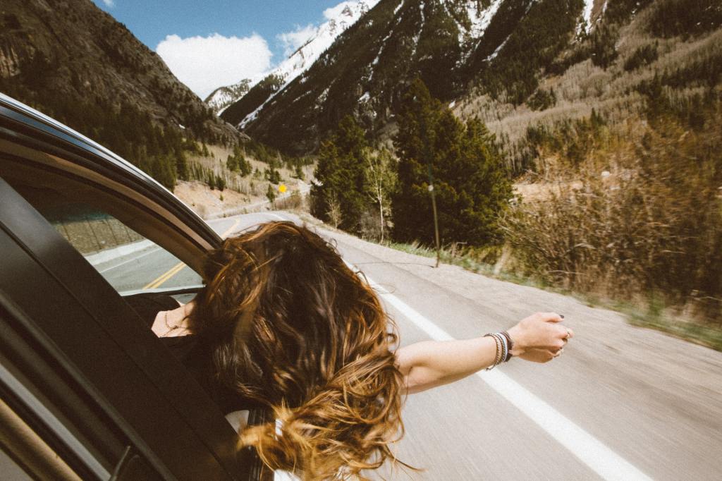 Woman leans out car window