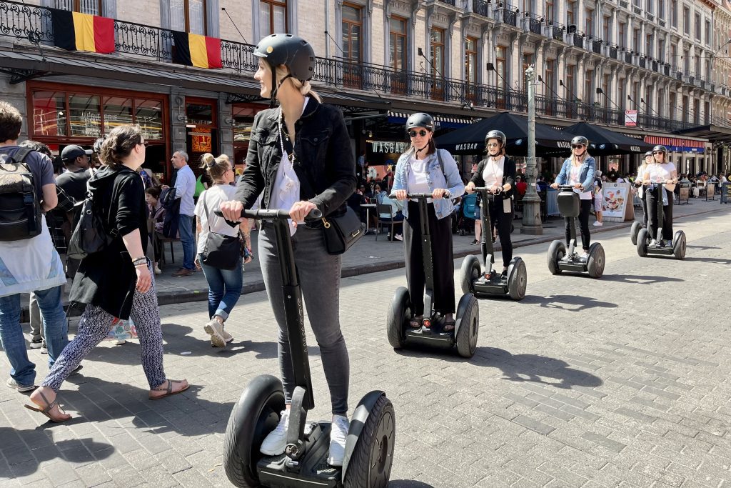 Tourists roll through Brussels, Belgium on a guided Segway tour. Europe is awash in tourists during the summer. 
