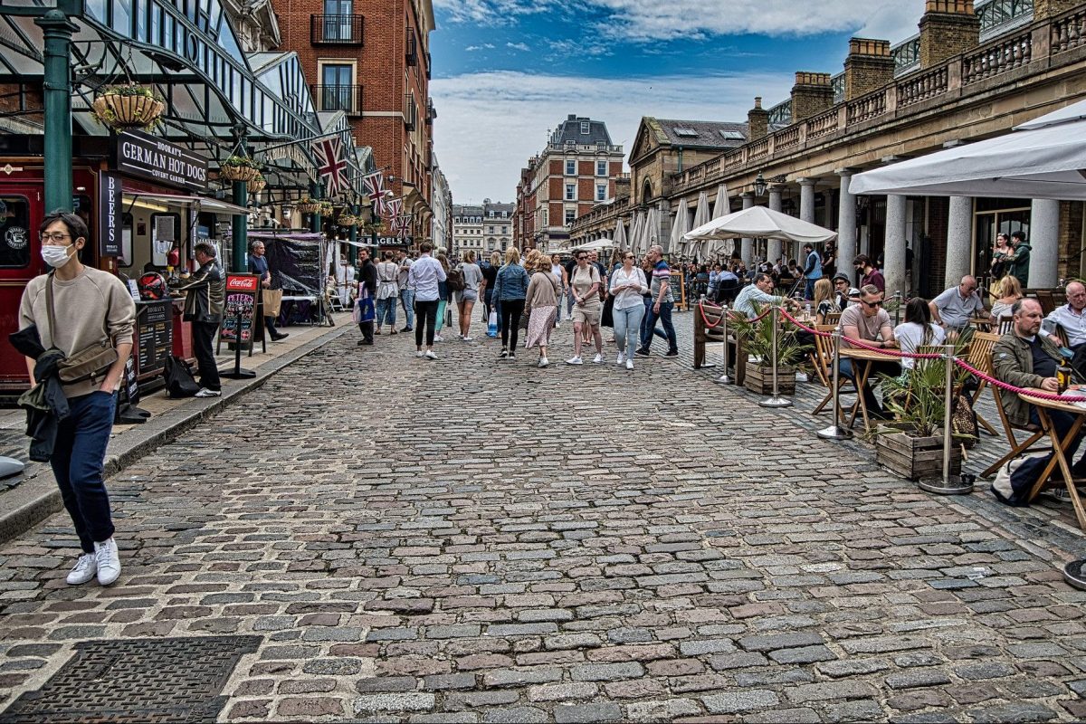 Tourists in London (like those pictured here in Covent Garden) are happy to see the Sterling pound devalued. 