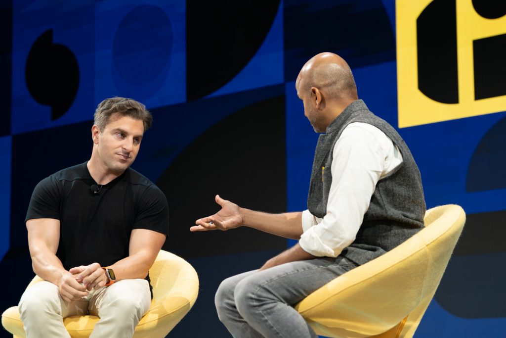 Airbnb co-founder and CEO Brian Chesky (left) spoke with Skift founder Rafat Ali at Skift Global Forum in Manhattan November 21, 2022. Airbnb will show the total price up-font.