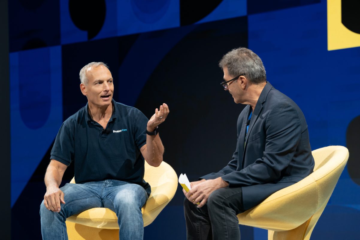 Booking Holdings CEO Glenn Fogel got the mostly highly valued compensation package among online travel executives in 2022. Pictured, Fogel (left) appears at Skift Global Forum in New York City in September 2022. Source: Skift