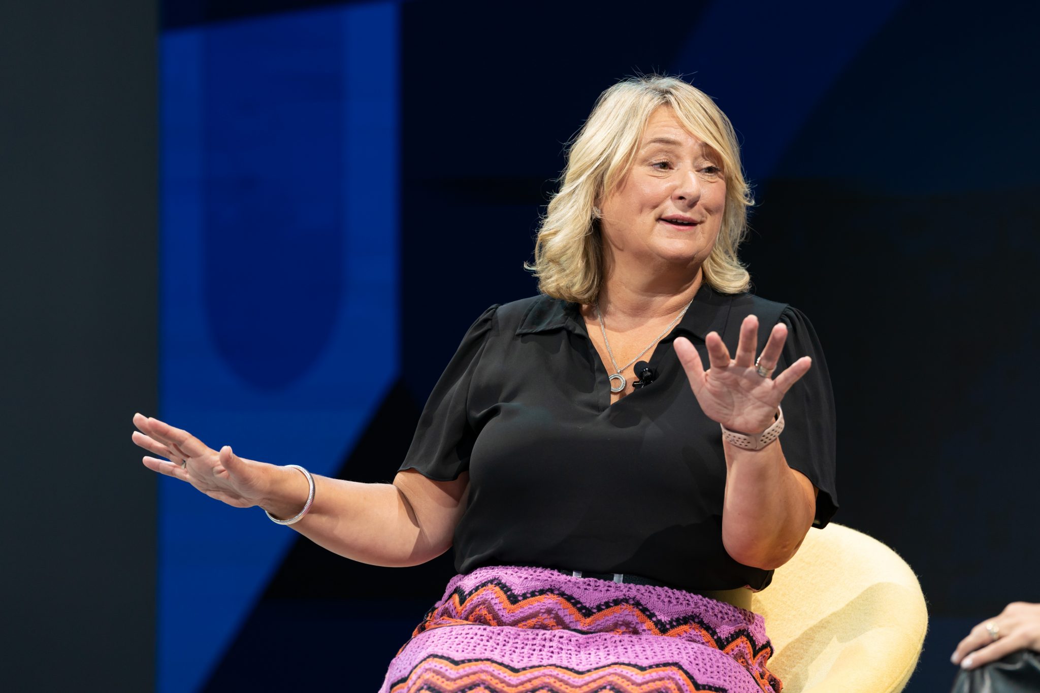 Audrey Hendley, president of American Express Travel, making a point on stage during a sponsored session at Skift Global Forum in New York City on Sept. 20, 2022.