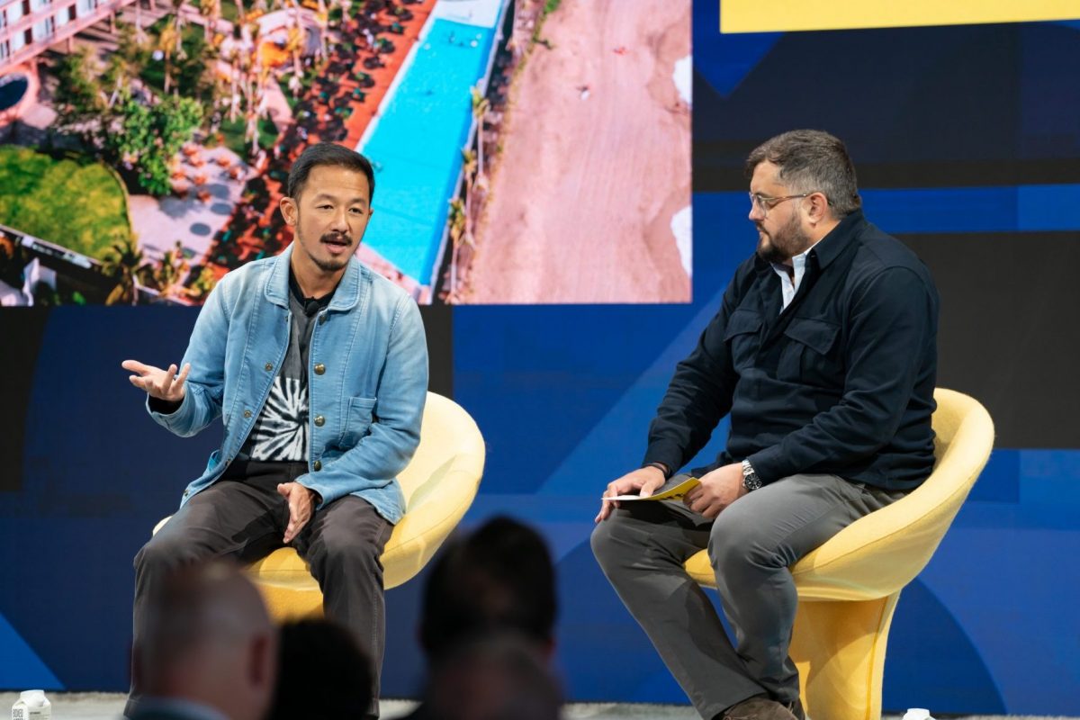 Potato Head Founder Ronald Akili on stage at Skift Global Forum in September, 2022, with Skift On Experience columnist Colin Nagy (right)