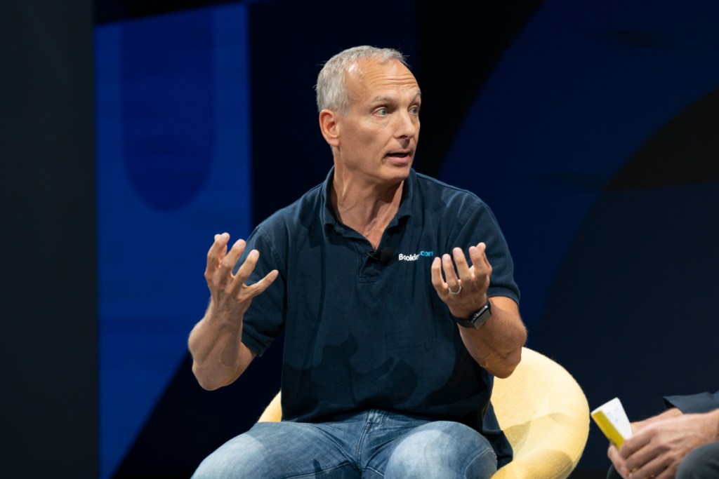 glenn fogel, ceo of booking holdings, talking onstage at skift global forum event