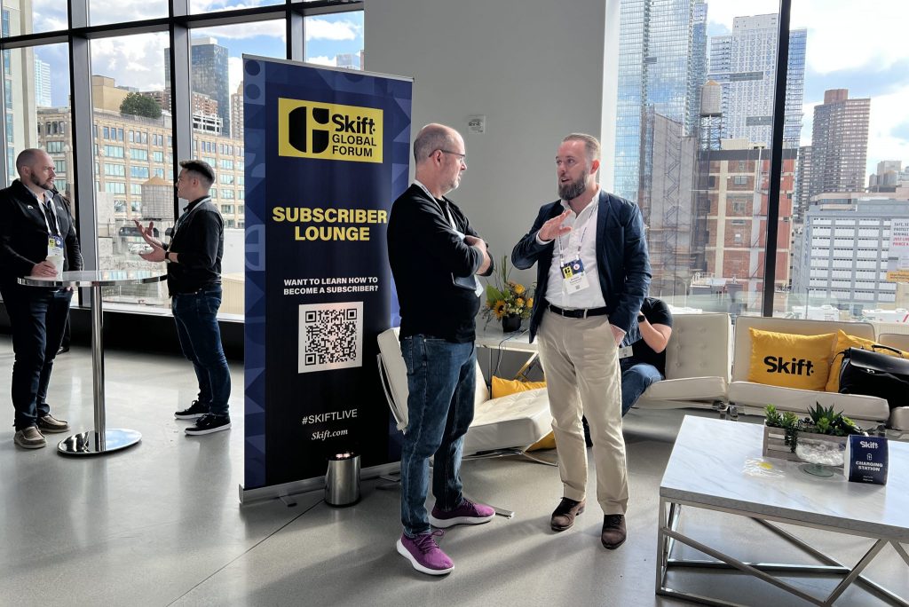 A valued subscriber and event attendee (R) speaking with a low-level Skift staffer (L) at Skift Global Forum in New York City in September 2022. 