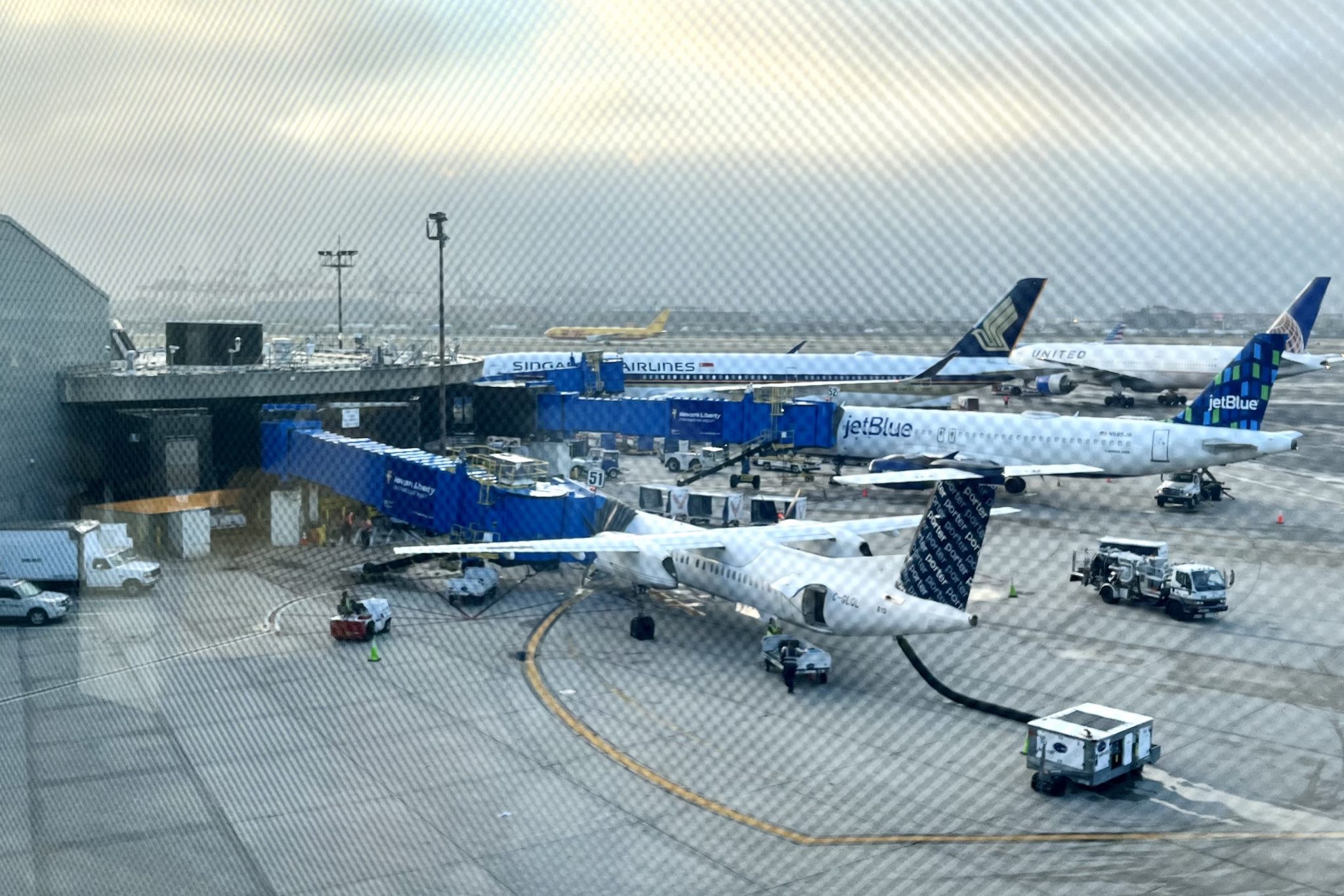 Porter Airlines, JetBlue Airways, Singapore Airlines, and United Airlines planes at Newark Airport. Source: Skift