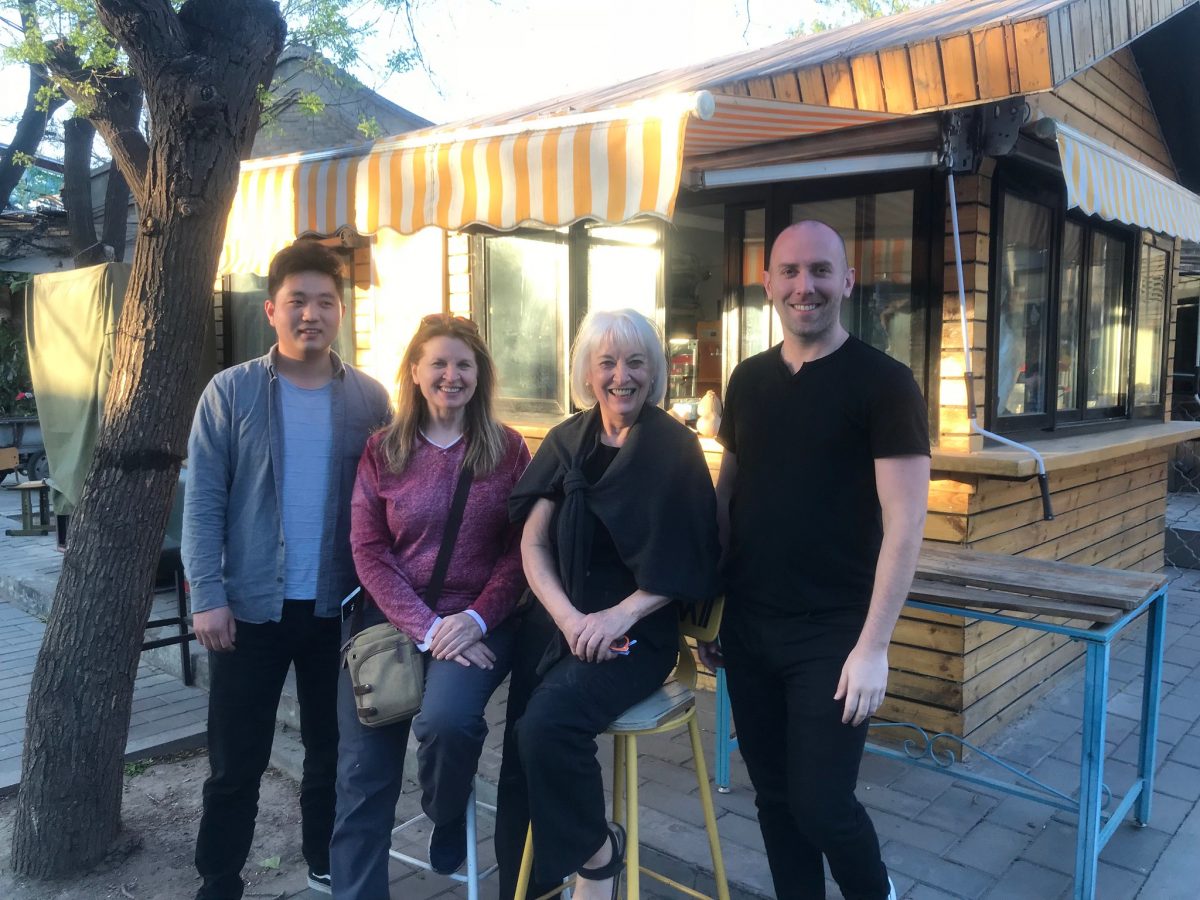 An Airbnb host (left) with guests on April 10, 2018 in Beijing. 
