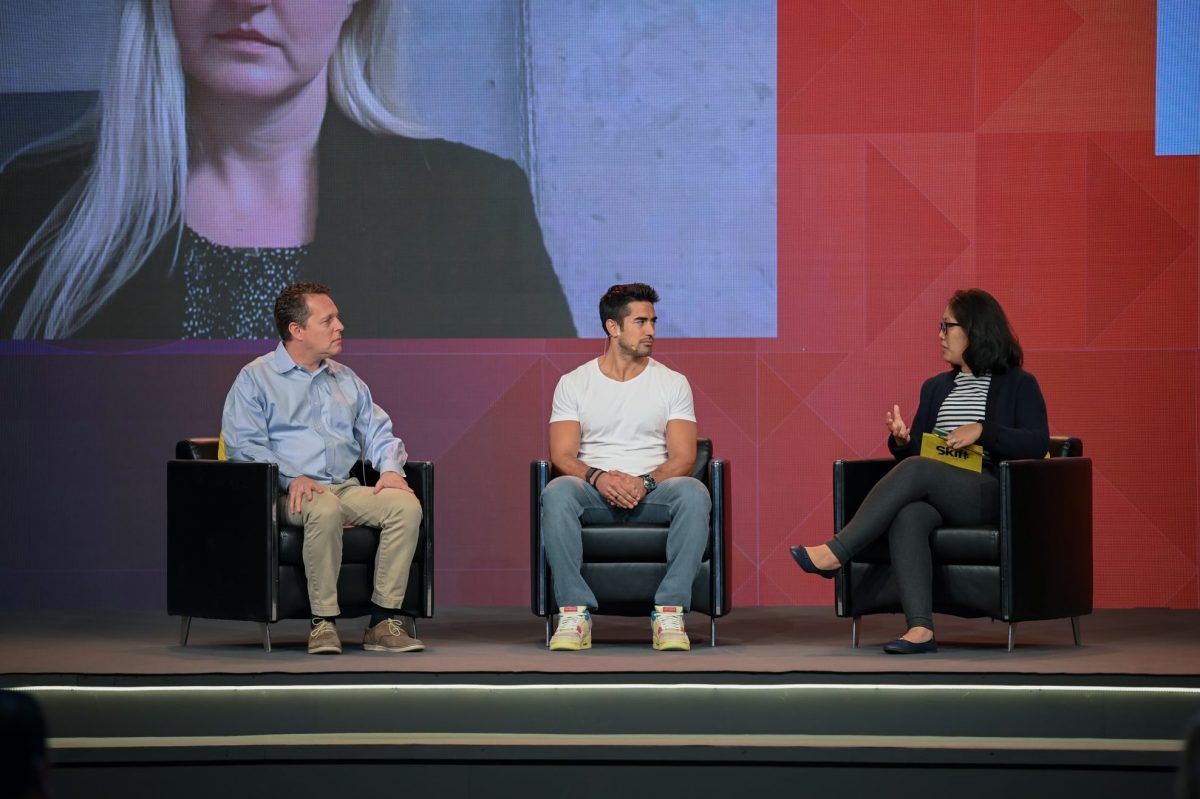Sigríður Dögg  Guðmundsdóttir, head of Visit Iceland (on screen),  Scott Brodows, head of third party advertising at Hopper, Jeremy Jauncey founder and CEO, Beautiful Destinations, with Skift Asia Editor Peden Bhutia on stage at Skift Global Forum East in Dubai.
