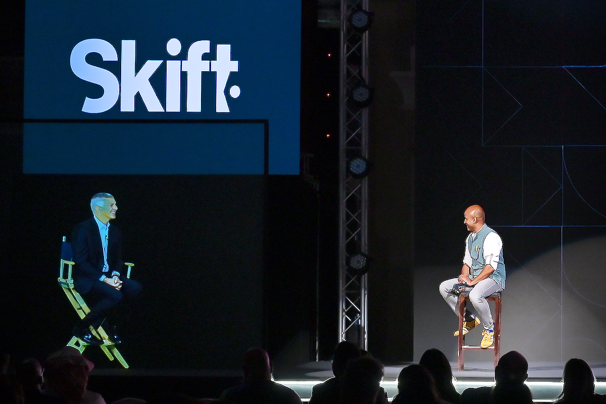 Hilton CEO Christoper Nassetta (left), appearing via a hologram, was interviewed by Skift founder Rafat Ali at Skift Global Forum East in Dubai December 14, 2022.