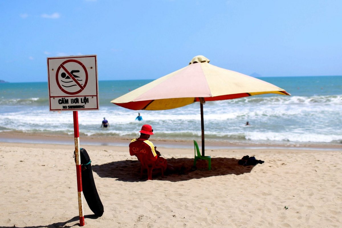 A lifeguard is seen sitting at the Nha Trang beach in Nha Trang city, Khanh Hoa province, Vietnam, which is seeing much fewer tourists these day.