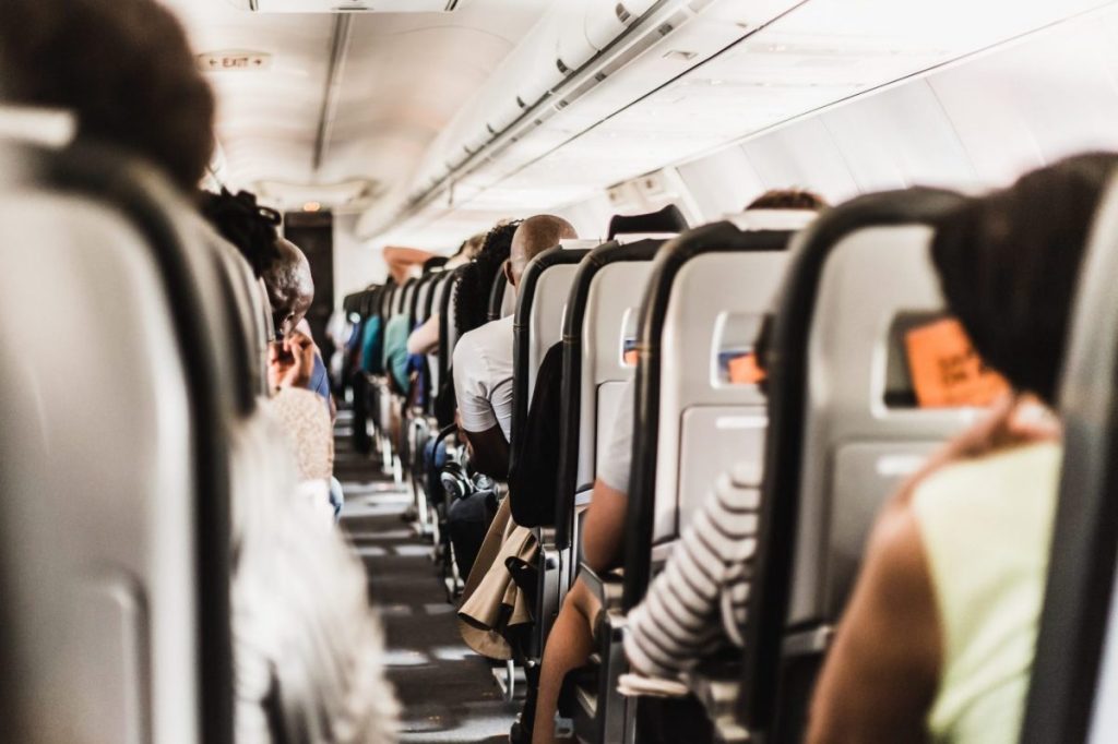 Passengers on a plane where they are faced with many airline fee options.