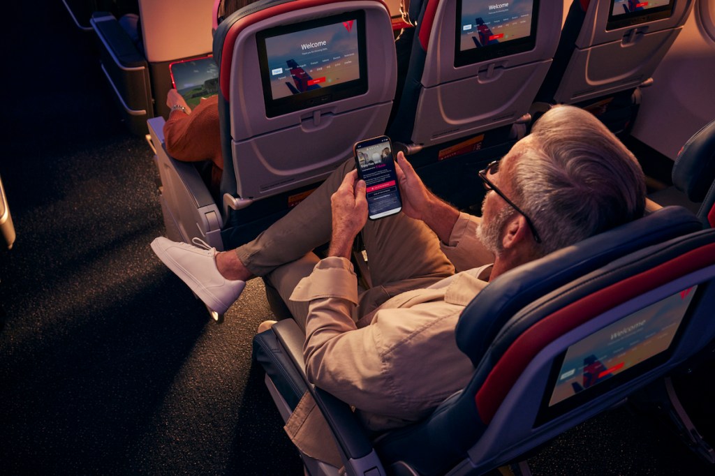 A traveler uses Wi-Fi on their device on a Delta flight