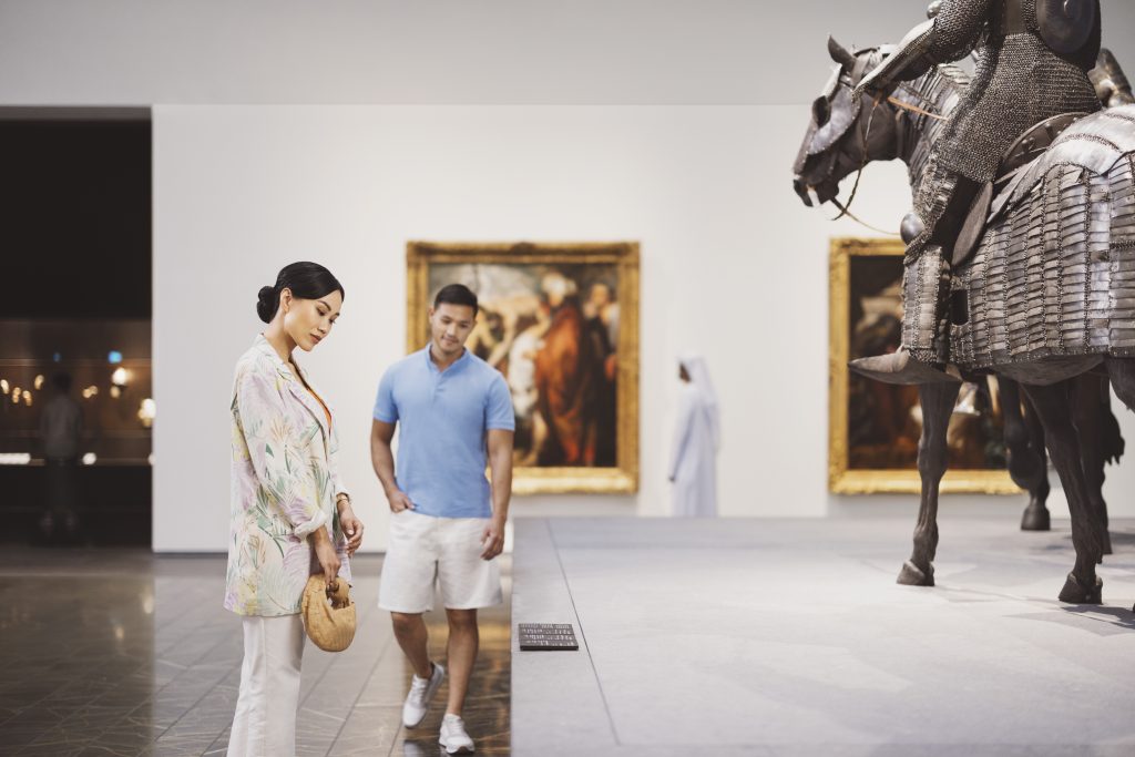 A couple looks at art at Louvre Abu Dhabi. 