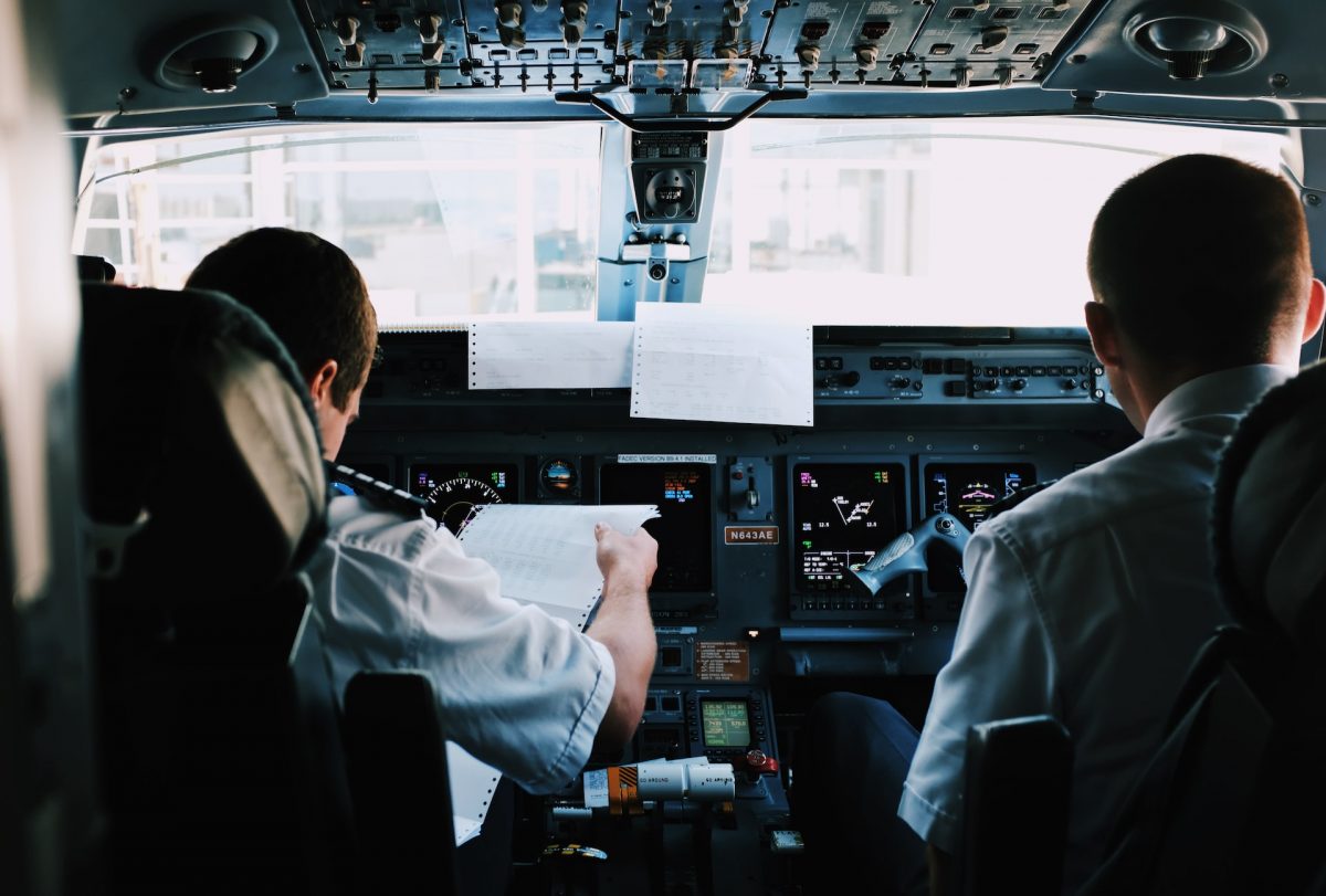 Two men in pilot's seat inside a plane. Source Blake Guidry / Unsplash