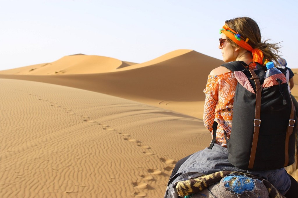 Woman riding in the desert.