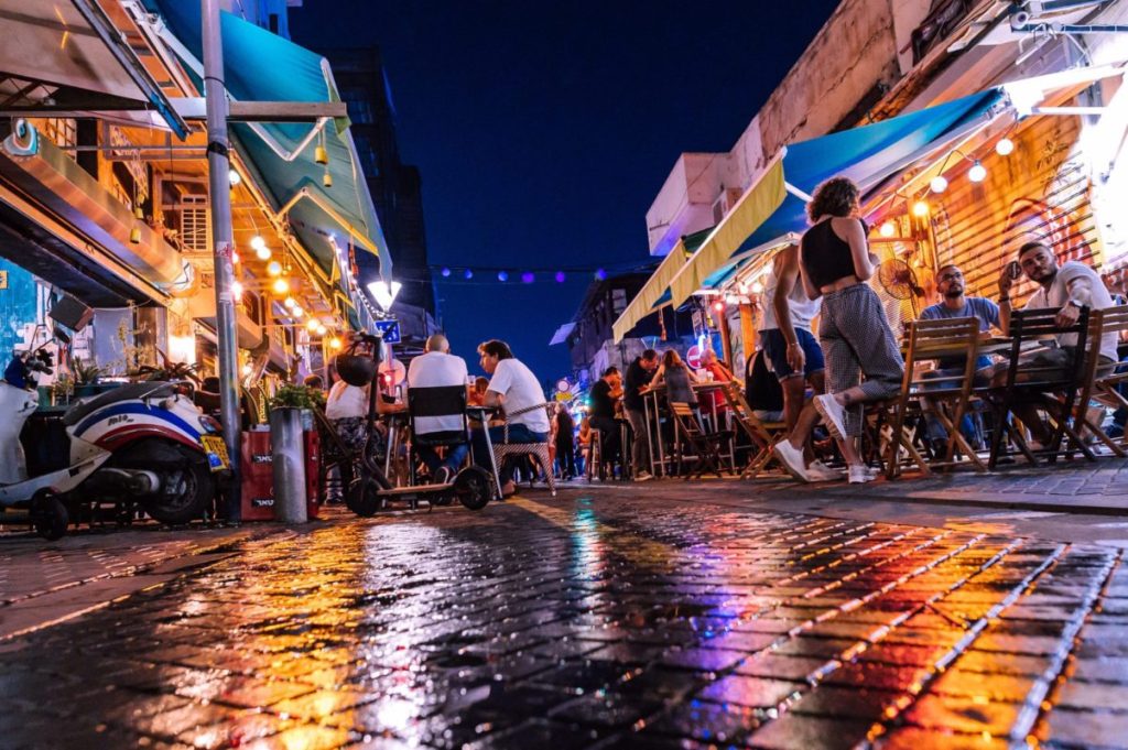 People sitting on chair near building at night time