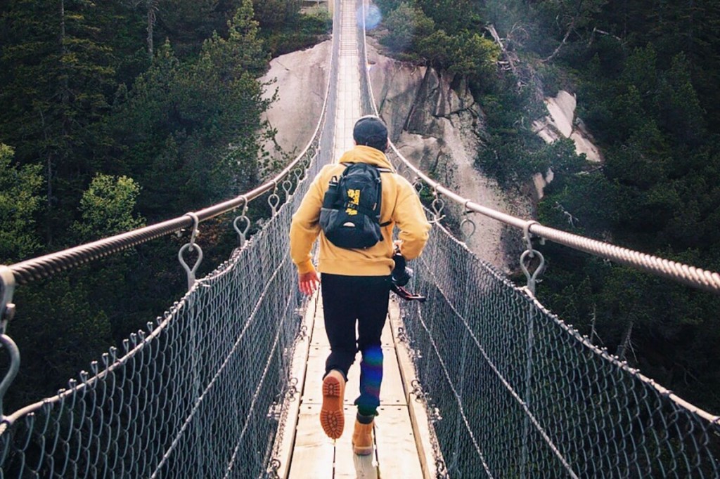 Man on a bridge in Oberland, Switzerland.