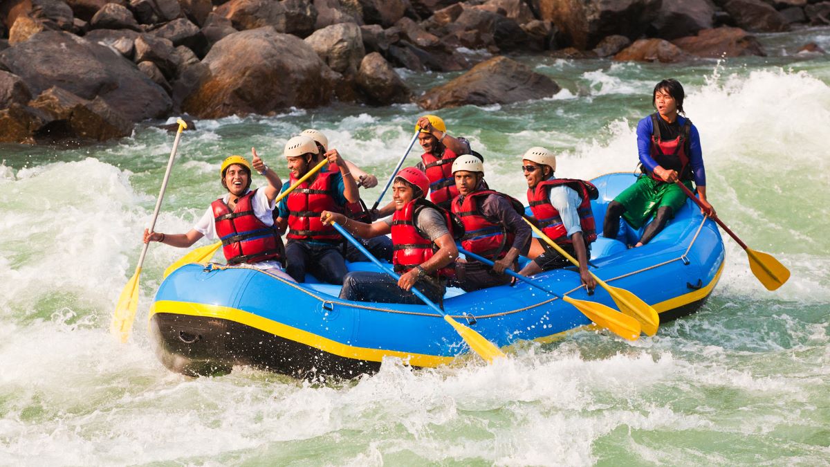 A group of adventure travelers river rafting. 