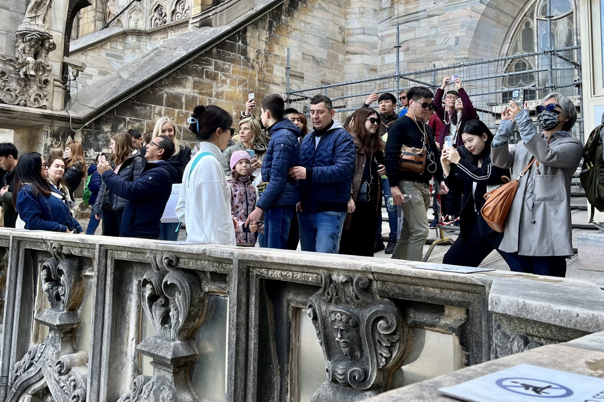 Tourists taking photos on the roof of Milan’s cathedral. 