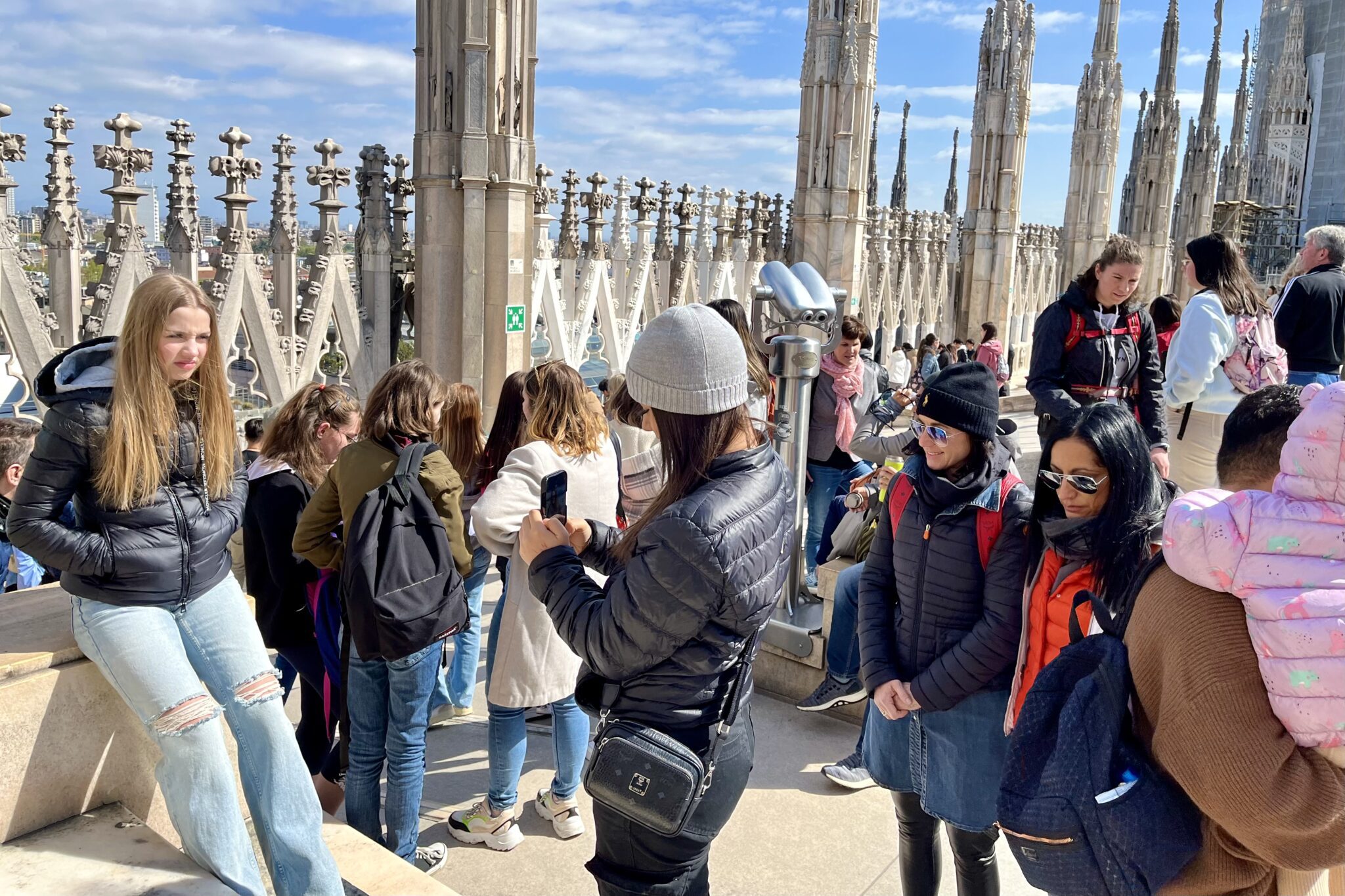 Tourists taking photos on the roof of the D’uomo cathedral in Milan, Italy. 