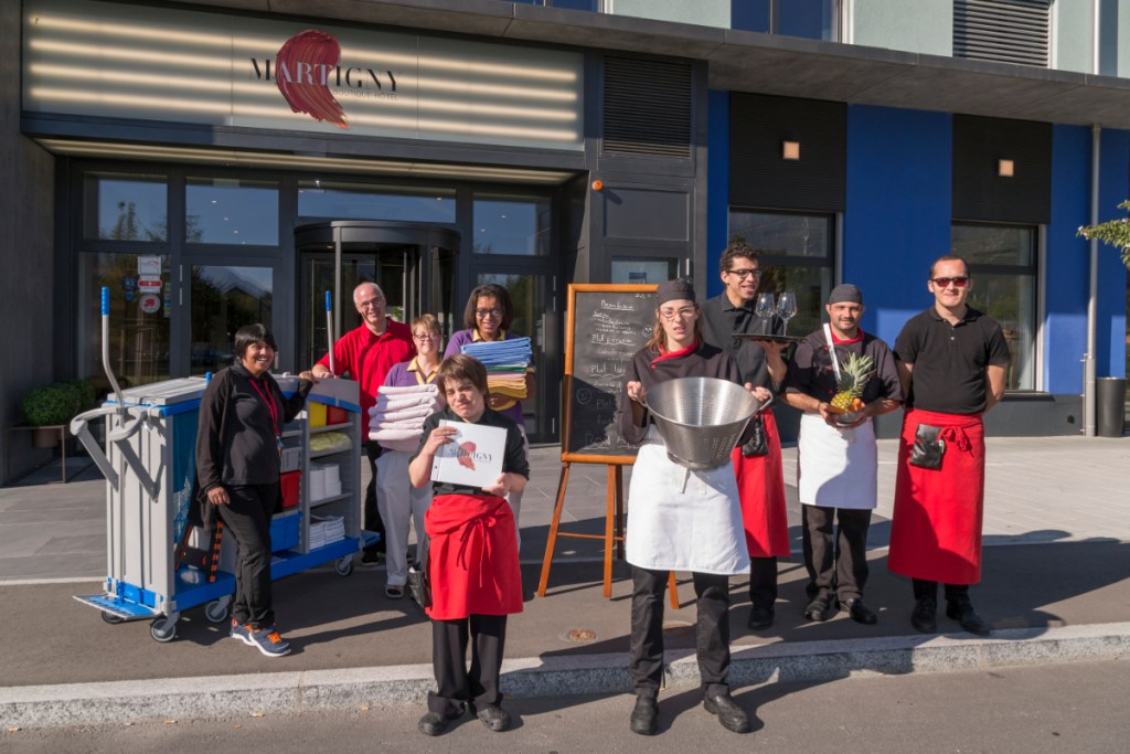 Staff members outside the Martigny Boutique-Hotel in Switzerland, which employs 40 people with intellectual disabilities