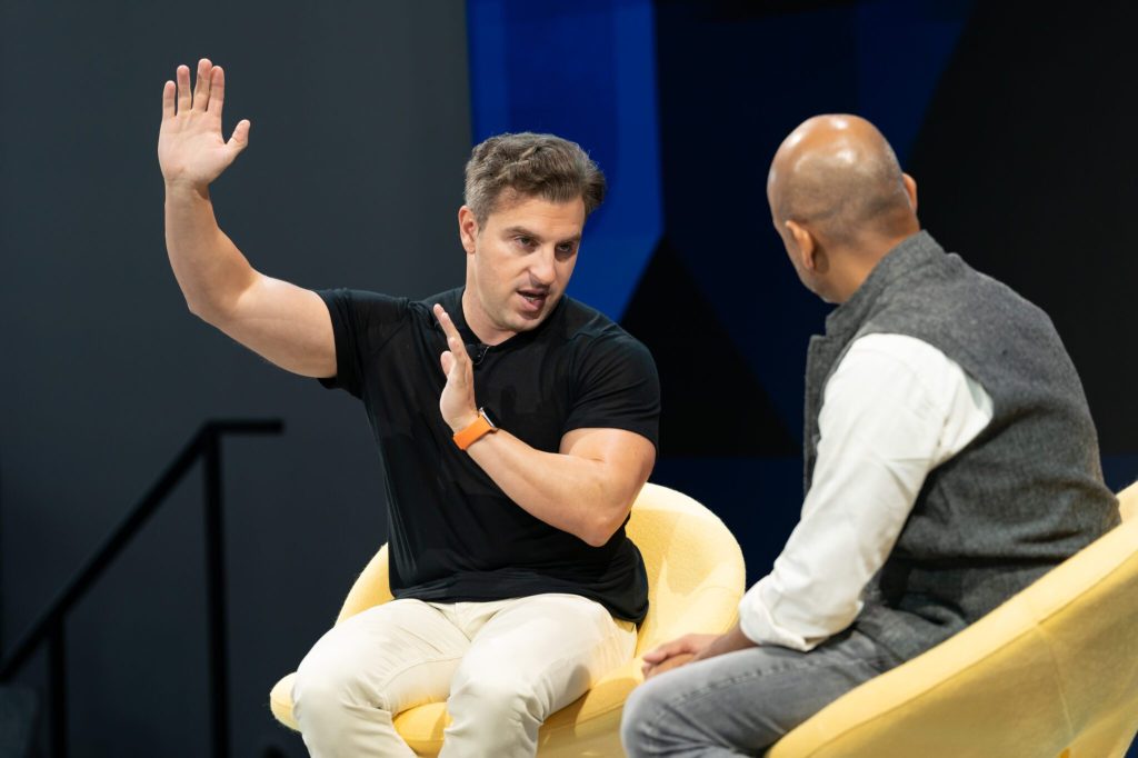 Airbnb CEO Brian Chesky speaking with Skift CEO Rafat Ali