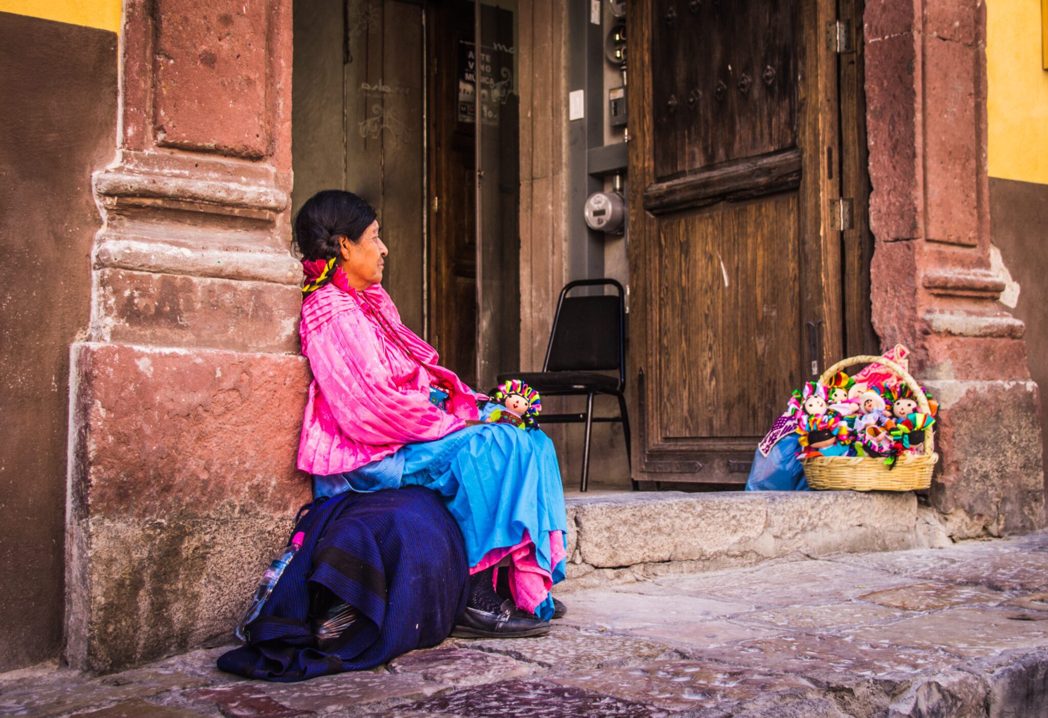 Indigenous Mexican woman selling dolls. Source: Unsplash 
