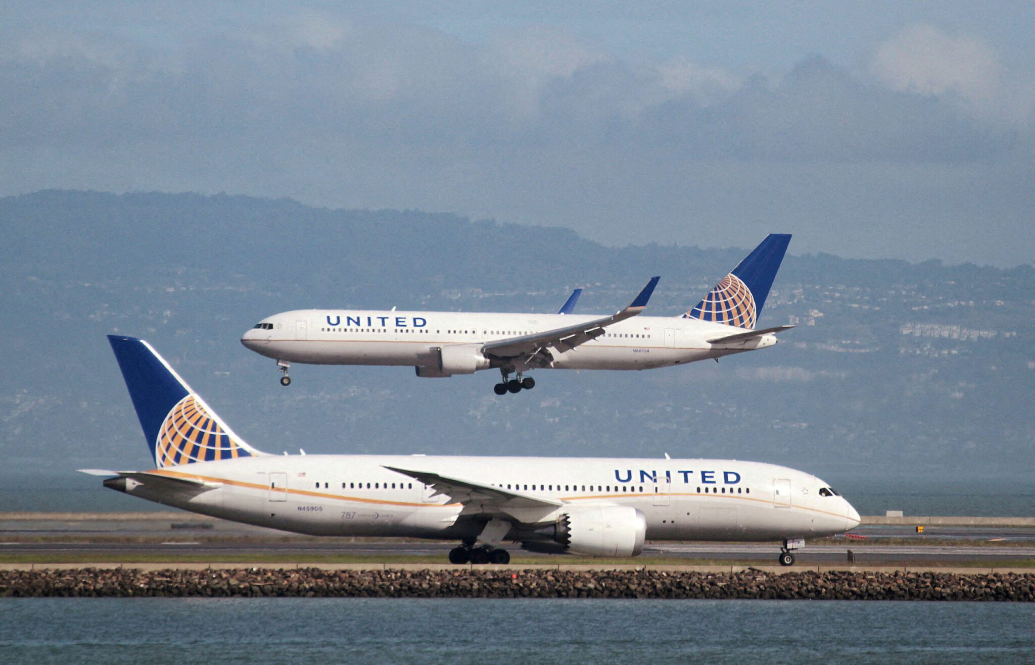 A United Airlines 787 taxis as a United Airlines 767 lands at San Francisco International Airport San Francisco. 