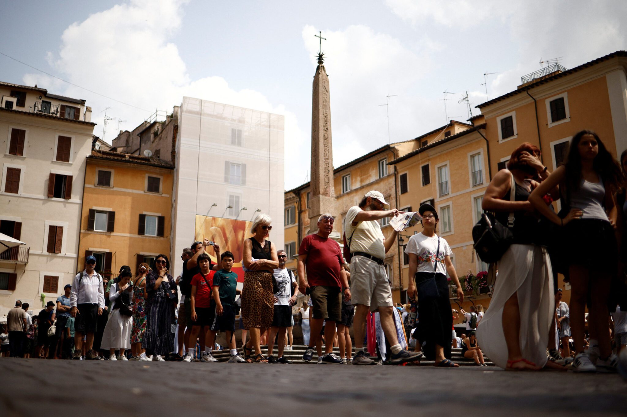 Tourists line up to visit the Pantheon in central Rome, Italy. 