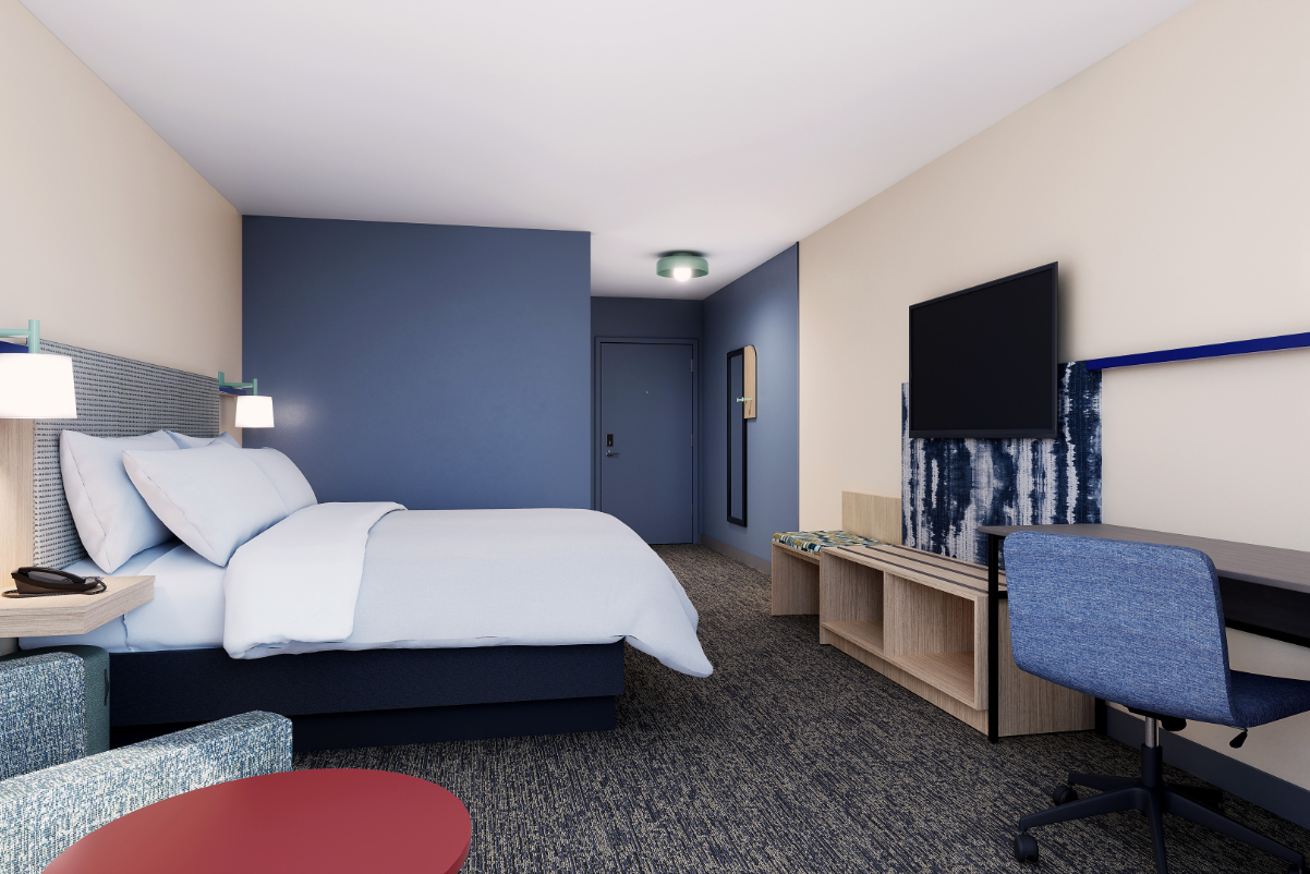 A view of a guest room with a king bed at IHG's new brand, Garner. 
