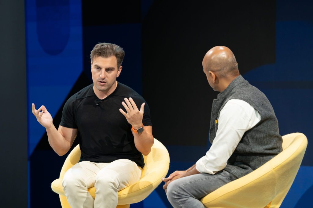 Airbnb CEO Brian Chesky speaking with Skift CEO Rafat Ali