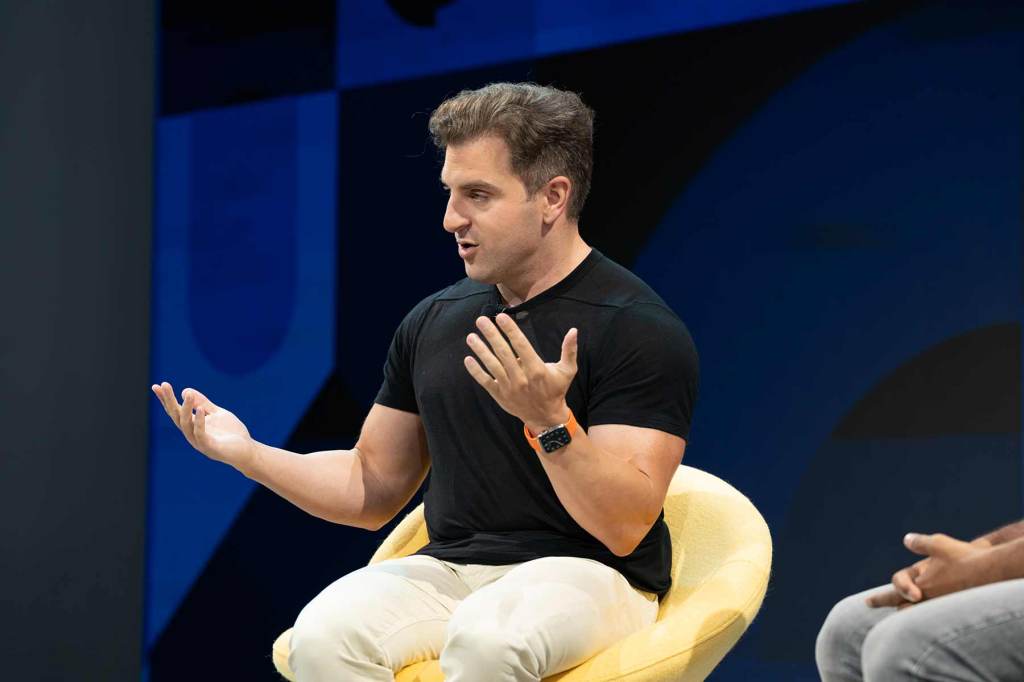 Airbnb CEO Brian Chesky speaking on stage