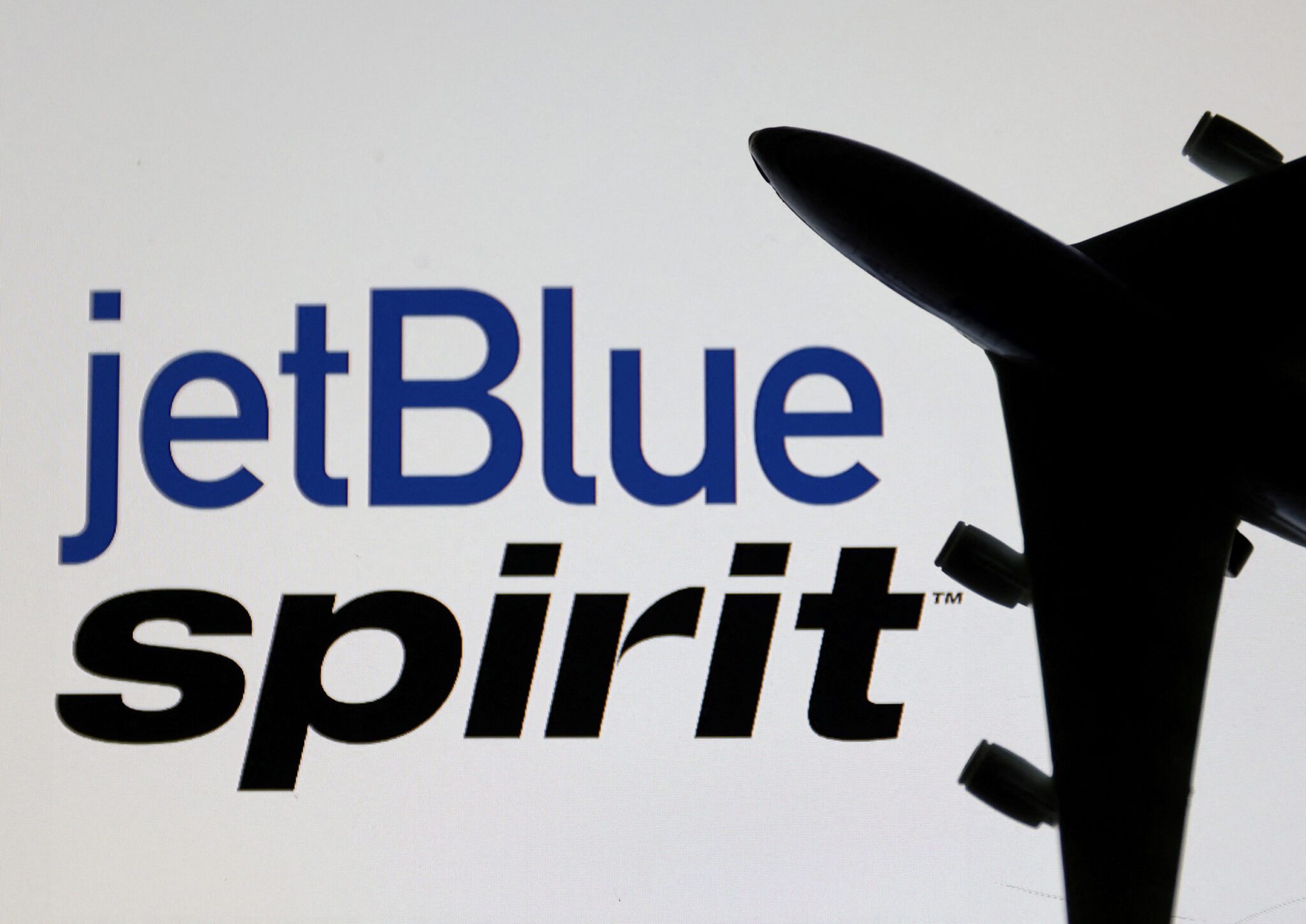 An illustration shows Spirit Airlines and jetBlue Airways logos scaled. 