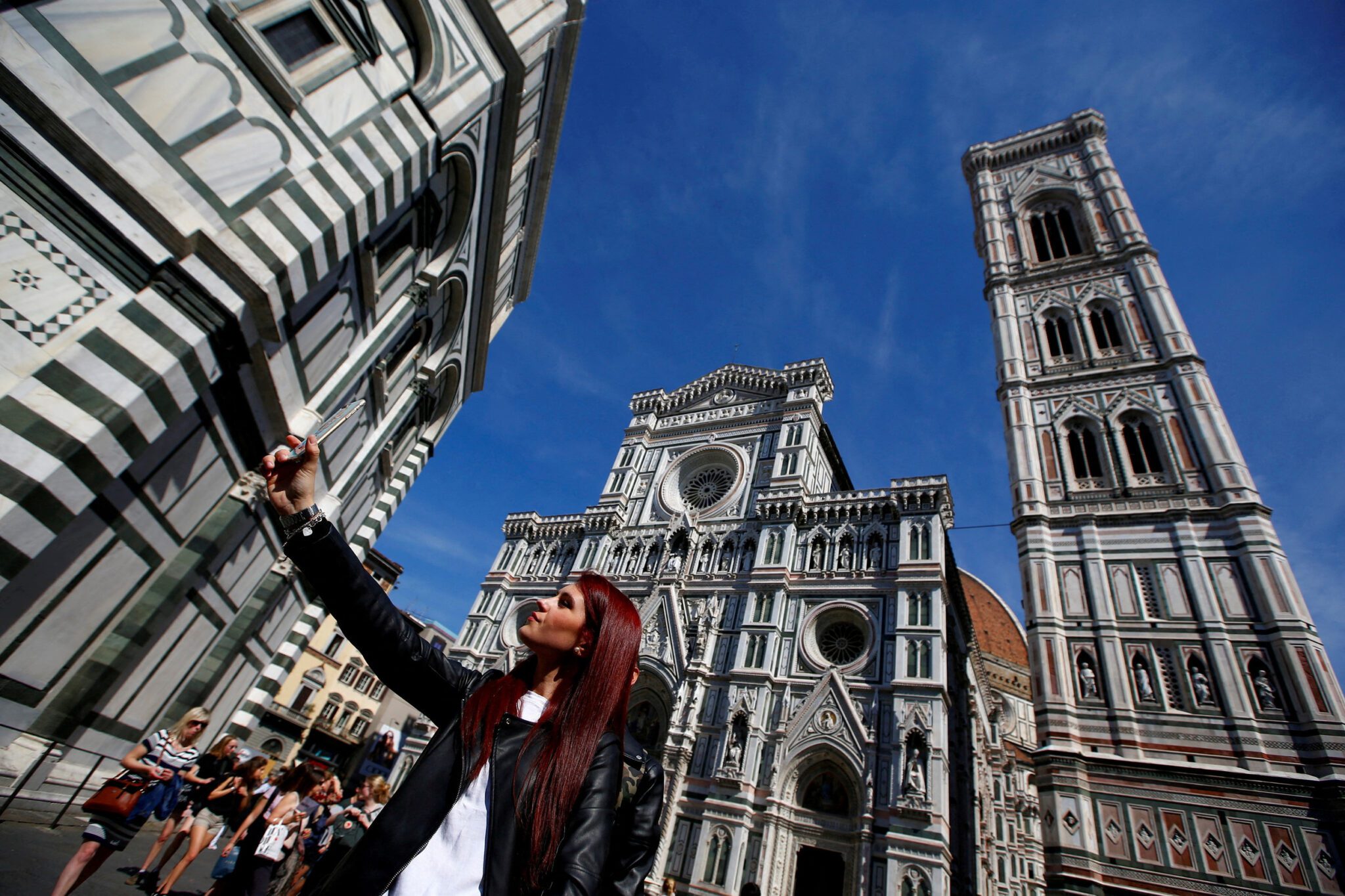 A tourist taking a selfie outside the Duomo in Florence. 