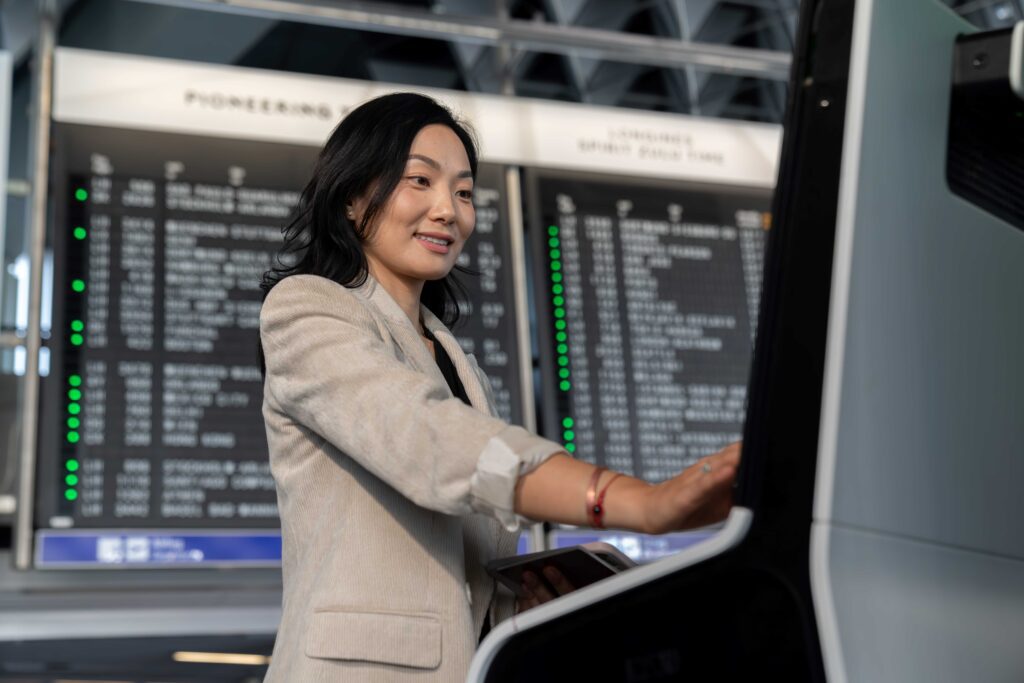 A female using a biometric system at an airport.