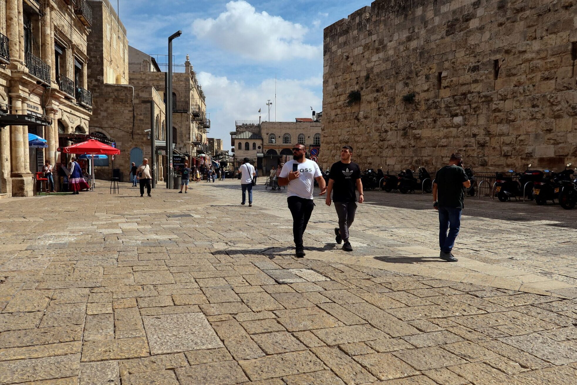 People walk into Jerusalem's Old City via Jaffa Gate, as the conflict wreaks havoc across the tourism sector October 11, 2023. 